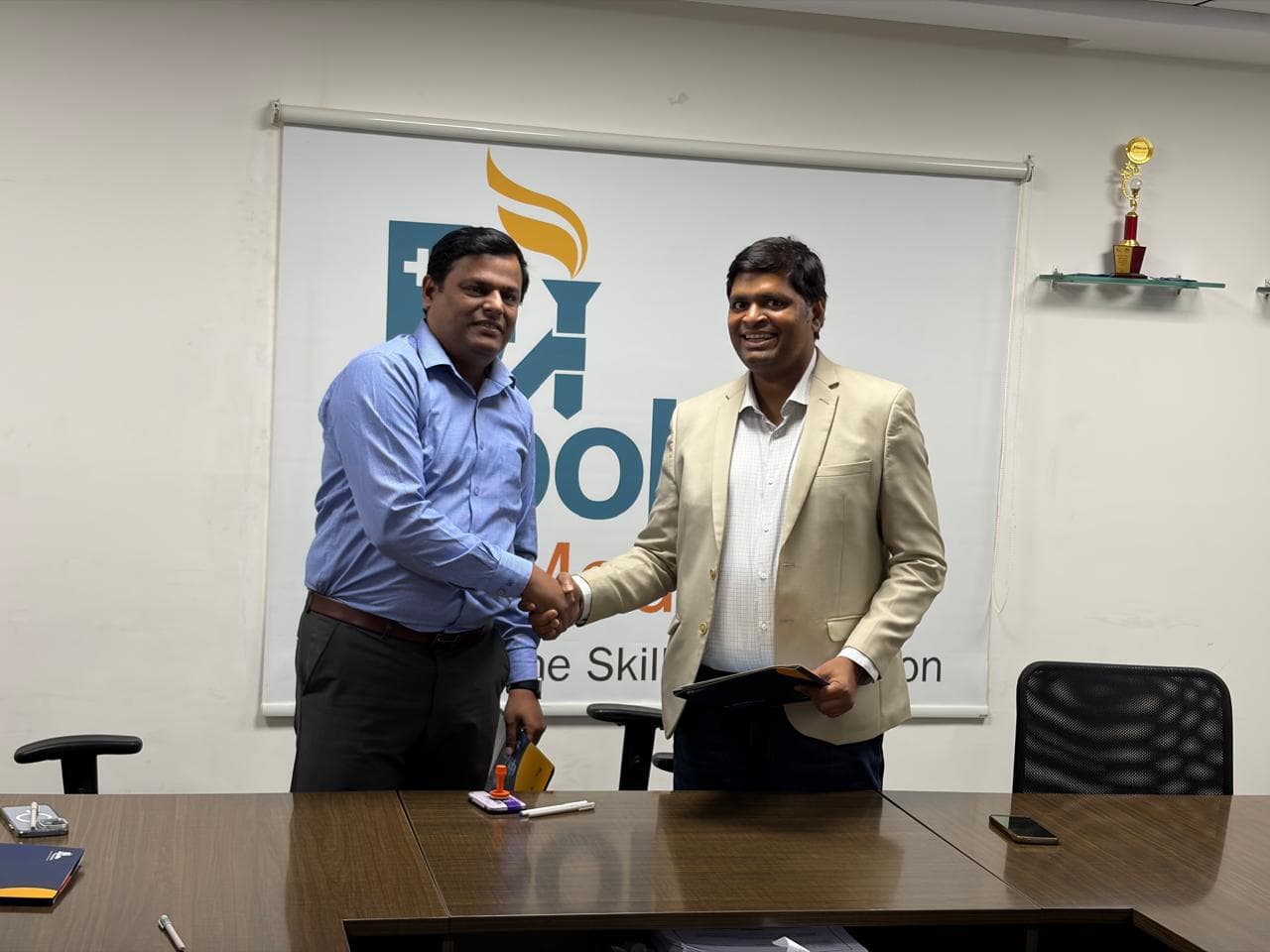 Partners shake hands after signing the collaboration agreement